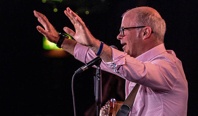 Askins raises his hands on the Store stage