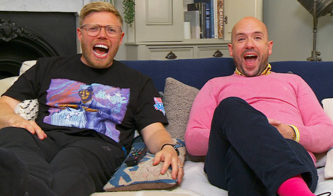 Tom and Rob laughing on the sofa