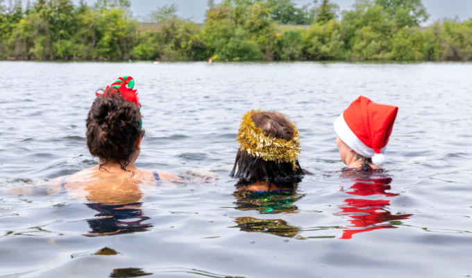 Glacier publicity shot - three women's heads as they swim in a lake