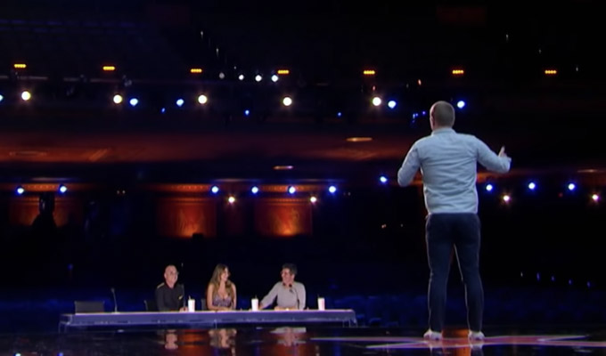 Hastings on stage in an empty theatre