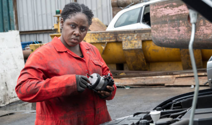 Siloah Coke as a car mechanic in Herbert Clunkerdunk