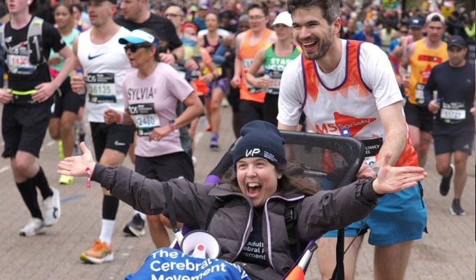 Ivo pushing Rosie around a previous marathon