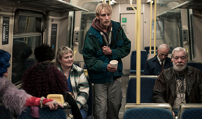 Man asking for change on a tube carriage