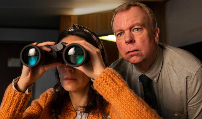 Sian looking through binoculars with Pemberton over her shoulder