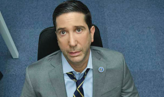 Schwimmer in Intelligence, sitting on office chair