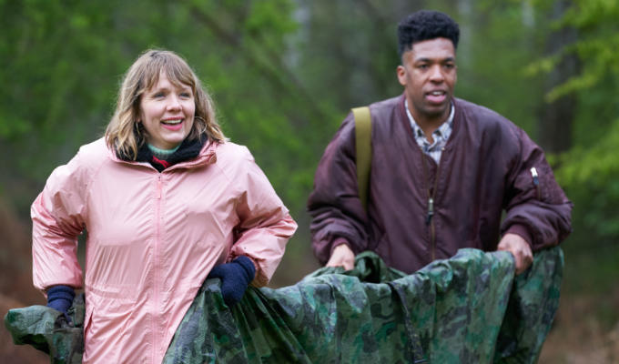 Kerry and Toussaint on Outsiders, carrying a canvas stretcher