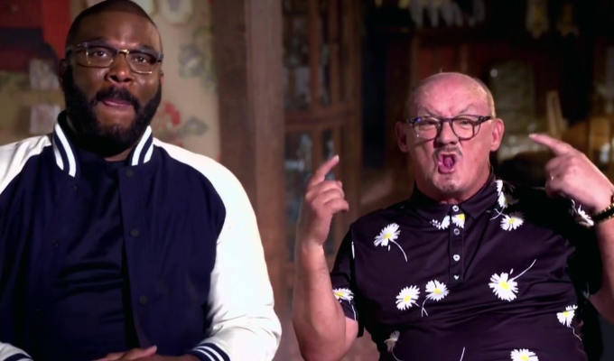 Ocarroll pulling a strange face as he appears on the One Show with black comic Tyler Perry
