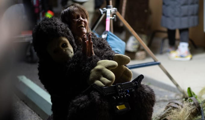 Nina half inside human-sized monkey costume