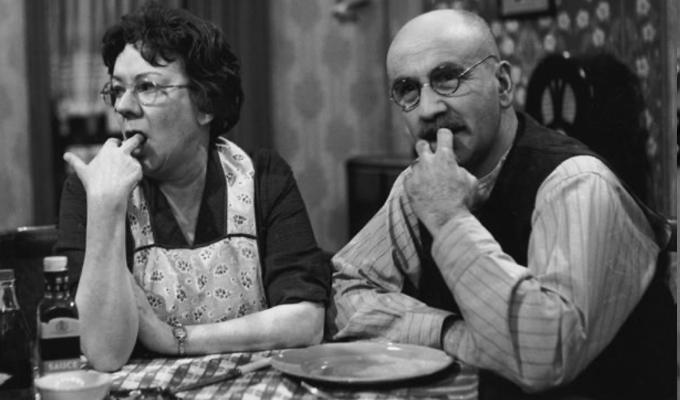 Alf and Elsie at dinner table with fingers in their mouths