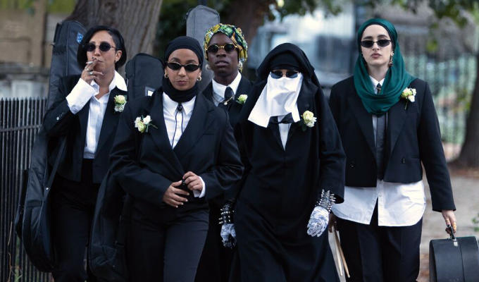 Lady Parts band outside in black suits