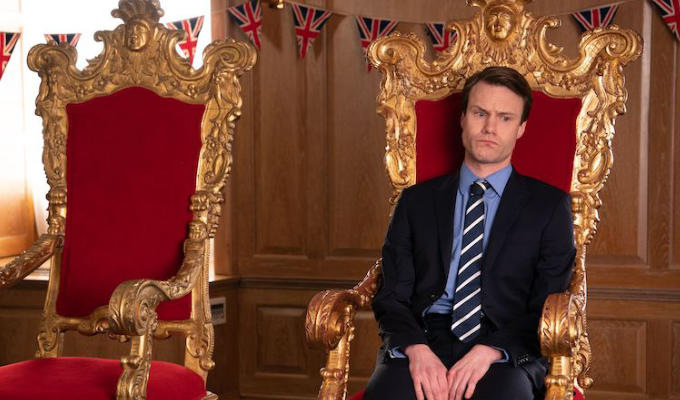 Hugh Skinner as wills looking glum on the throne with an empty throne next to him